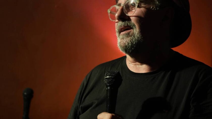 Comedian performing stand-up on stage at Madrid Comedy Festival