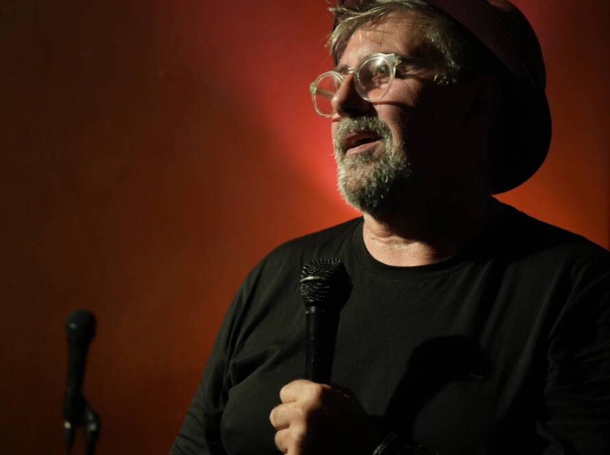 Comedian performing stand-up on stage at Madrid Comedy Festival