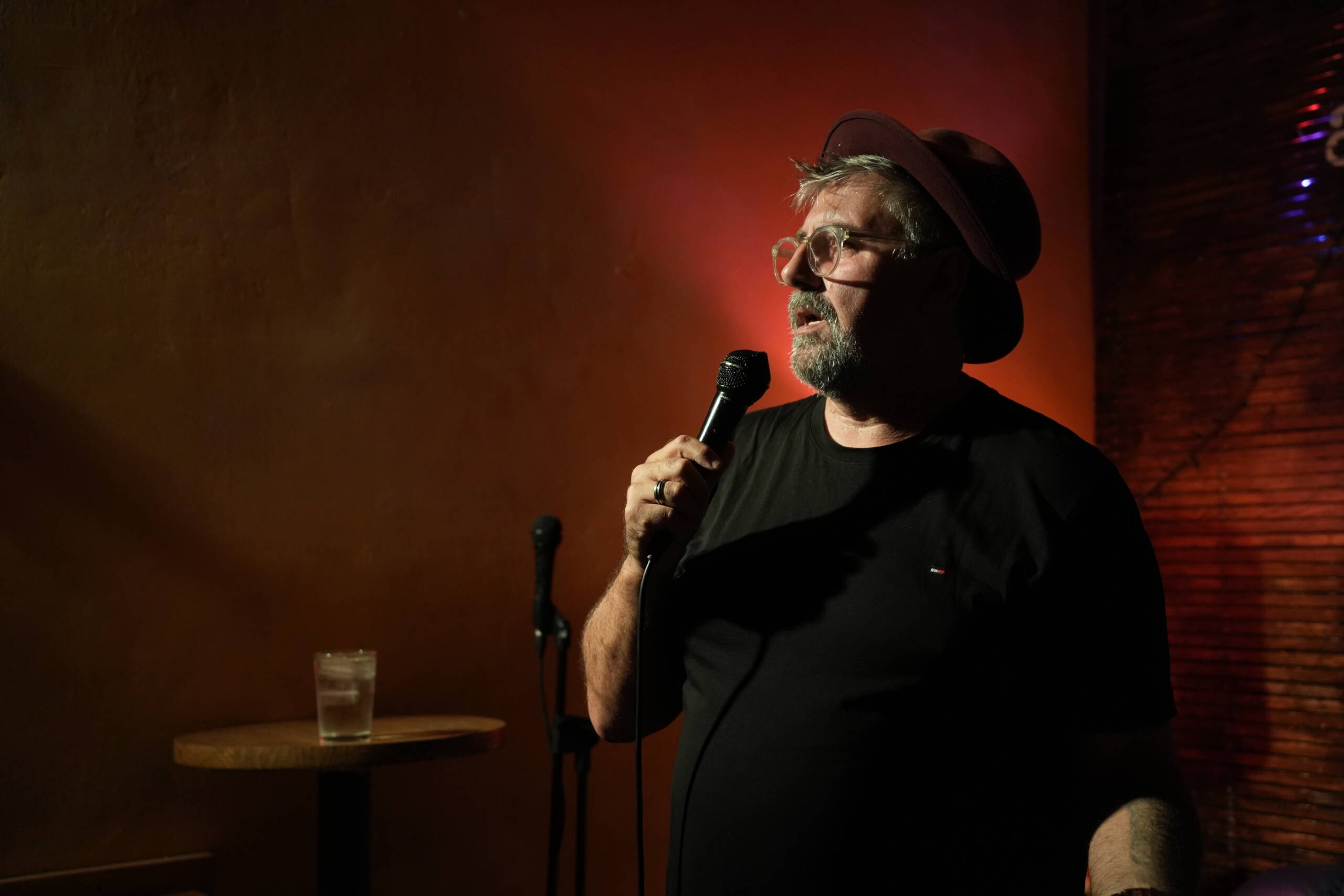 Comedian performing at an intimate comedy club show in Madrid