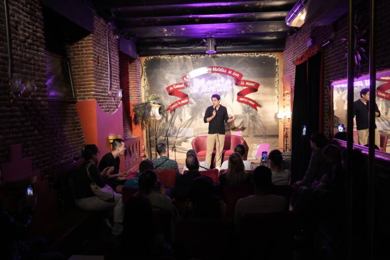 Wide view of Picnic during a show, with the audience in red armchairs