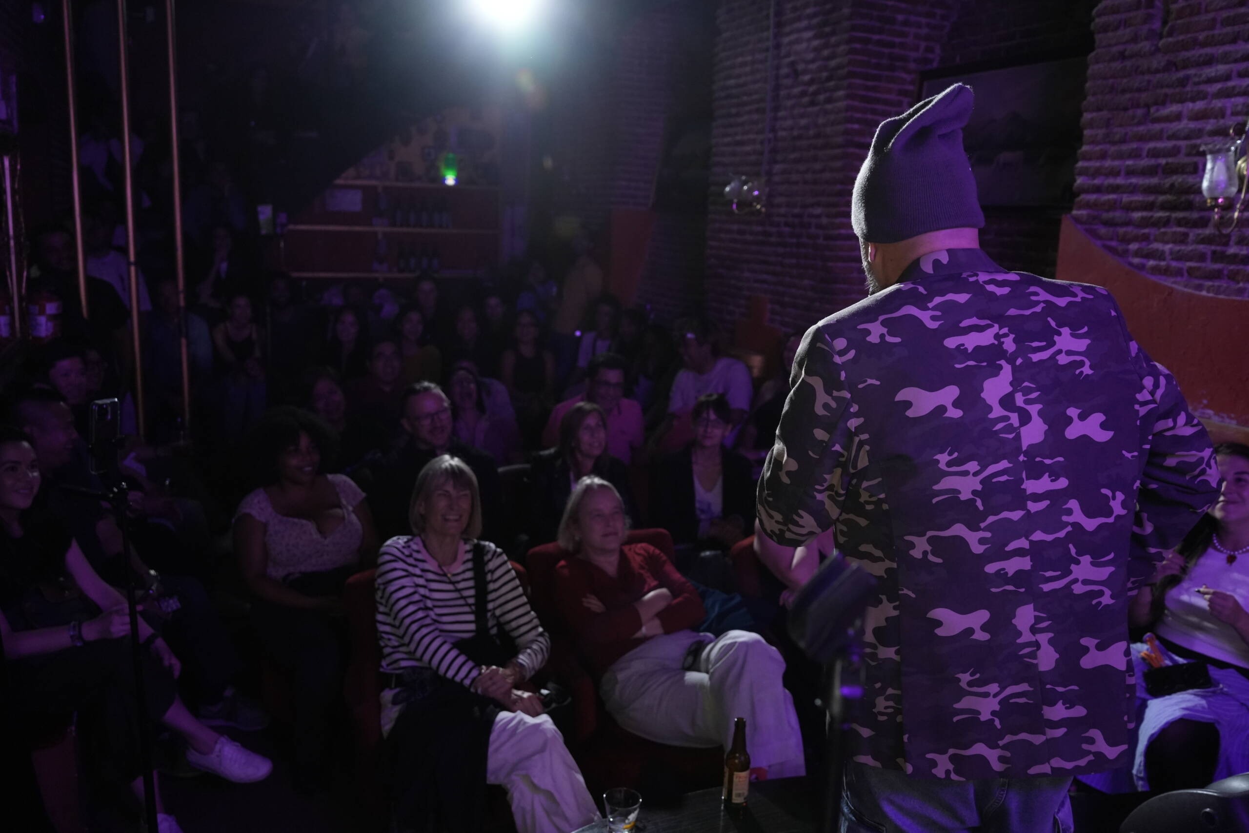 Comedian performing stand-up on stage at Madrid Comedy Festival