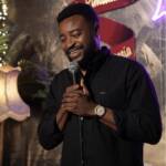 Comedian performing stand-up with a microphone at Madrid Comedy Festival