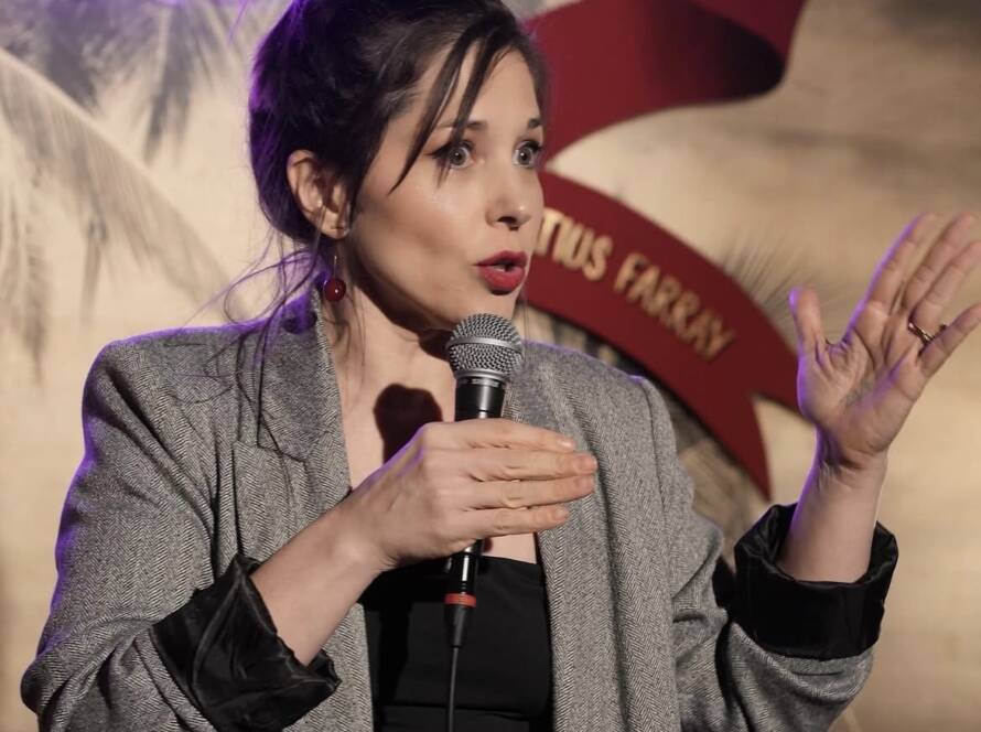 Comedian performing stand-up on stage at Madrid Comedy Festival