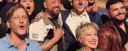 Comedians celebrating together on stage at Madrid Comedy Festival, wide crop
