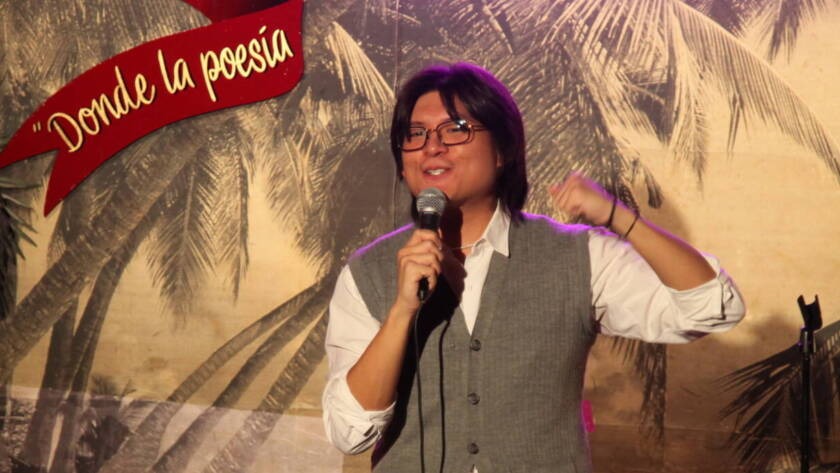 Comedian performing stand-up on stage at Madrid Comedy Festival, wide banner crop