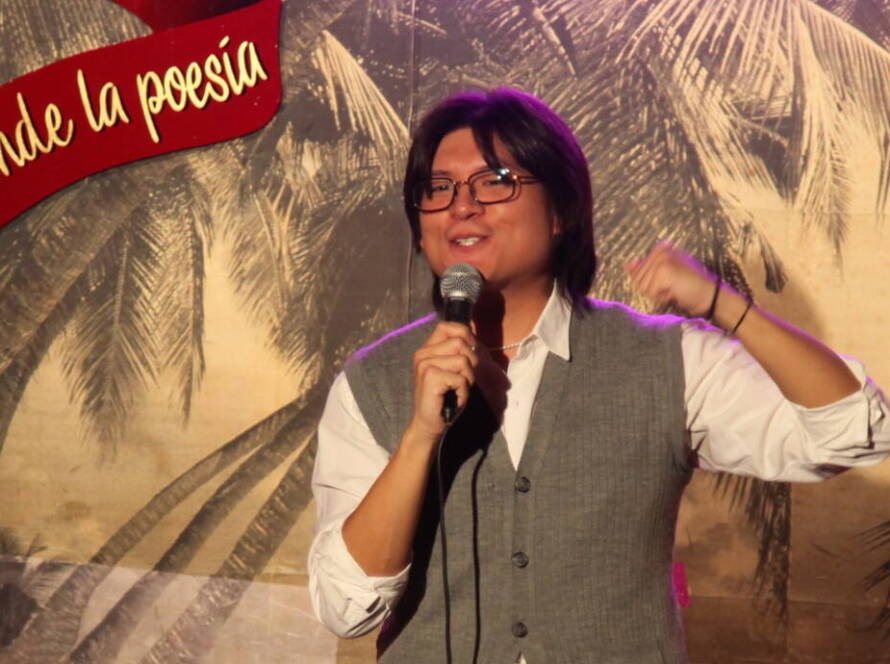 Comedian performing stand-up on stage at Madrid Comedy Festival, wide banner crop