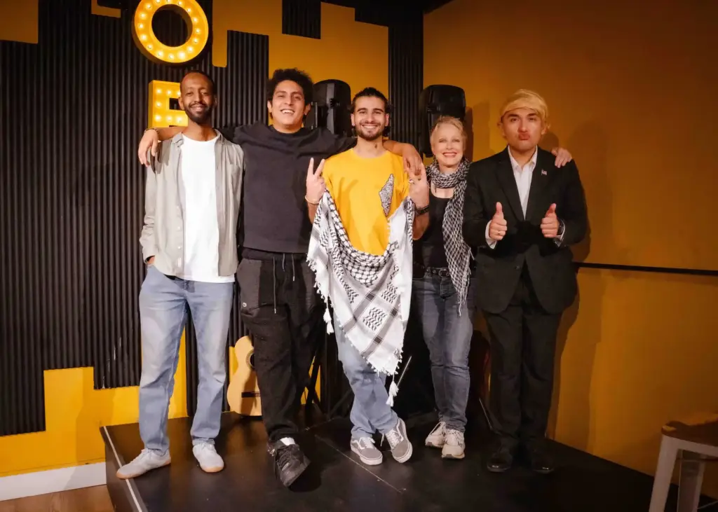 A group of performers posing together on stage after a show at Madrid Comedy Festival 2026