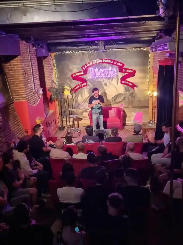 A full room at Picnic watching a comedian, taken from the back